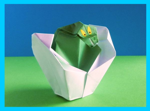 origami angry looking baby dinosaur in his egg