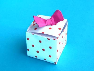origami giftbox with red polka dot pattern and a bow