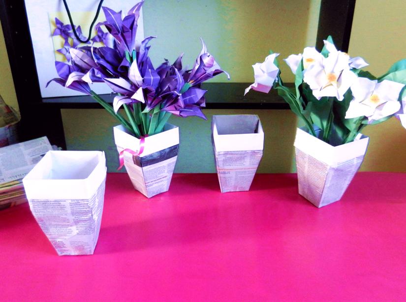 Origami flowers in newspaper pots