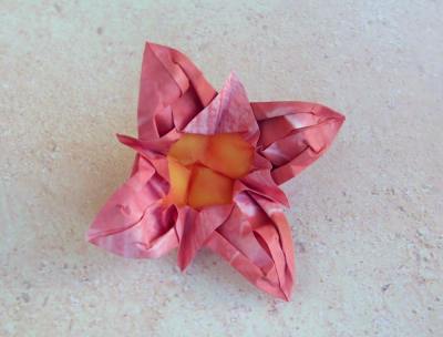 pink origami flower with a yellow center