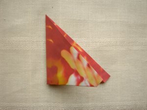 folding a red origami flower