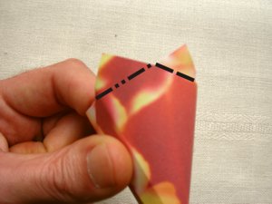 folding a red origami flower