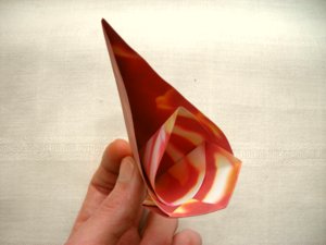 folding a red origami flower