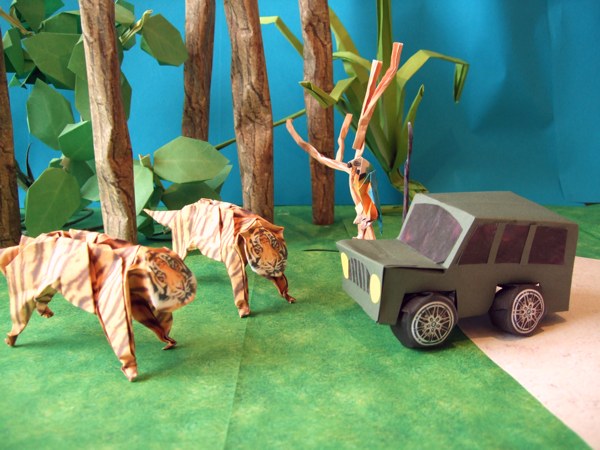 cool origami tigers standing in front of a jeep