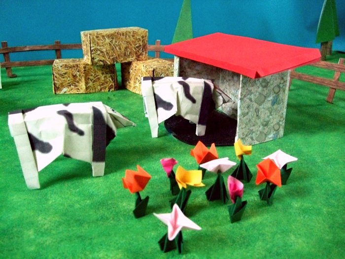 origami cows on the land of a farmer
