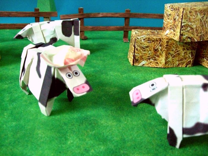 two funny origami cows talking to each other