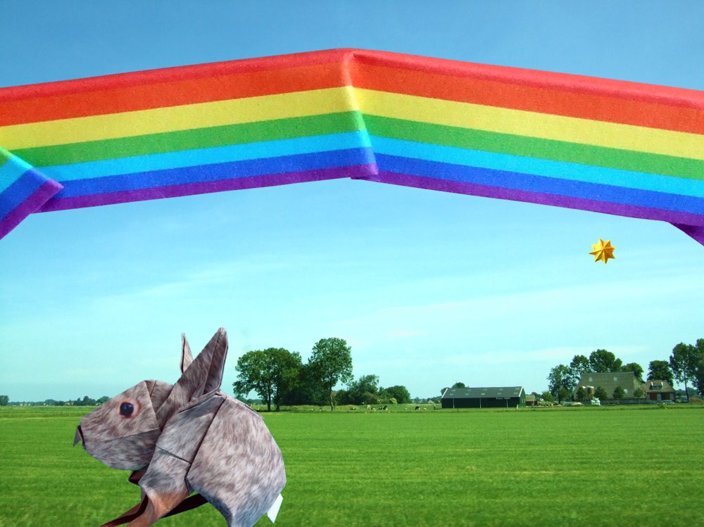 card with a cute origami rabbit in front of a rainbow