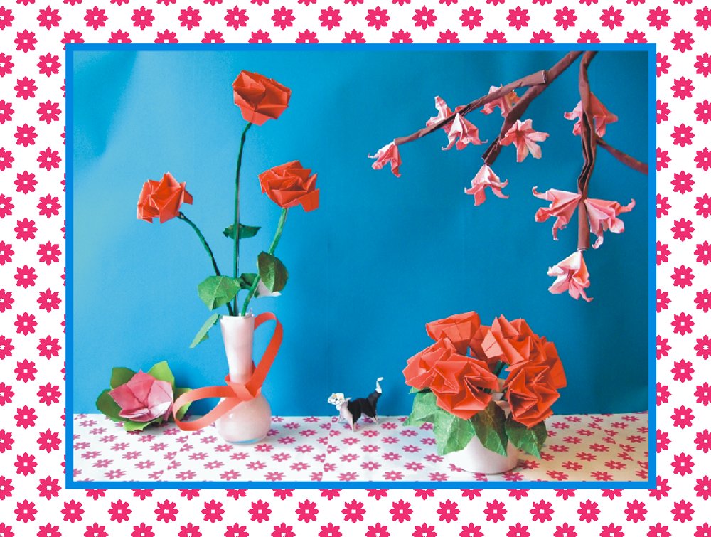 free card with red origami roses on a table