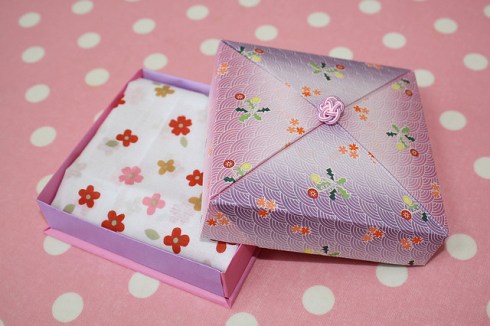 origami box on a pink polka dot background