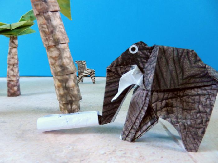 origami elephant rolling up a treasure map