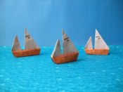 Origami sailboats on the ocean
