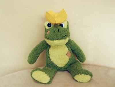 funny frog with an origami crown on his head