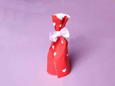 an origami gift box with a bow