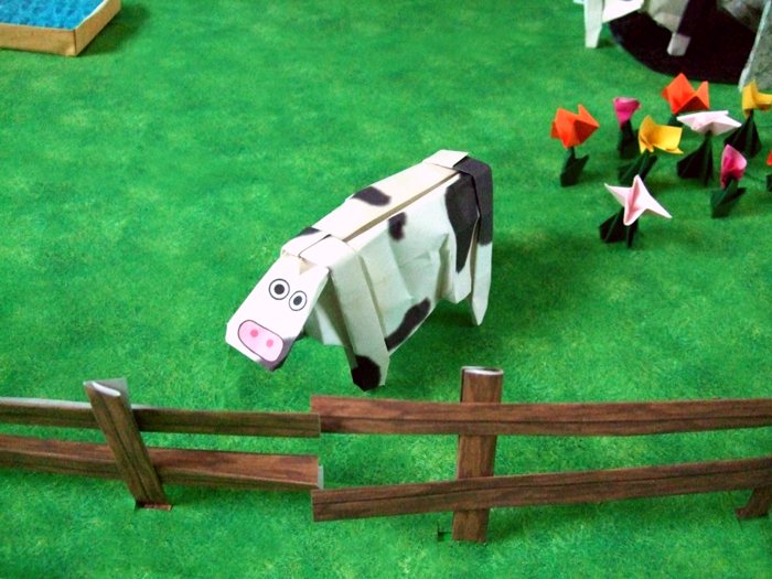 funky origami cow on a field