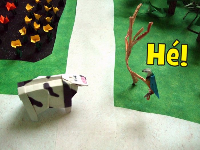 origami cow running to a paper tree