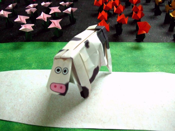 origami cow surrounded by paper flowers