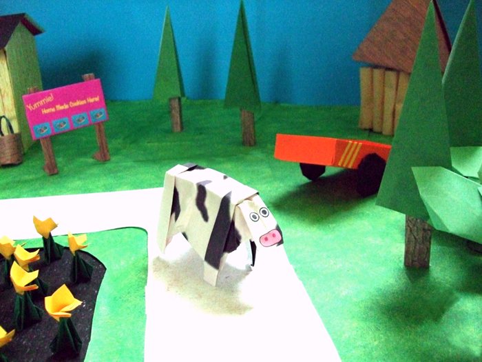 origami cow and a kirigami wagon