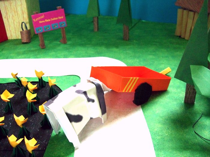 cow pushing a kirigami wagon off the road