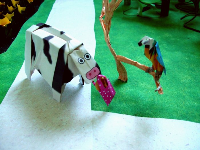 cow trying to sell origami cookies to a parrot