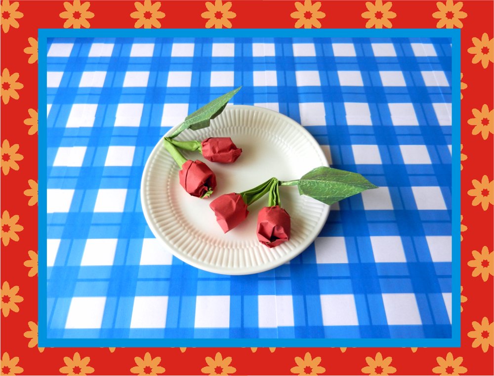 card with red origami cherries on a plate