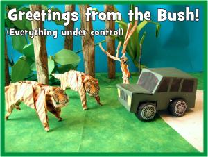 Card with two origami tigers in front of a kirigami jeep