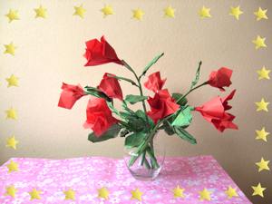 Card of a vase filled with red origami roses