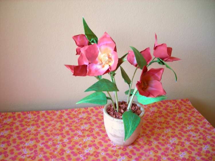 Card with red origami flowers in a pot