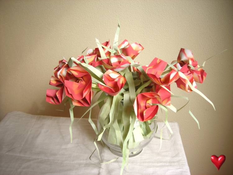 Card with cute red origami flowers in a vase