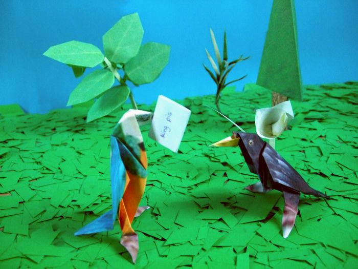 origami parrot giving a letter to a bird