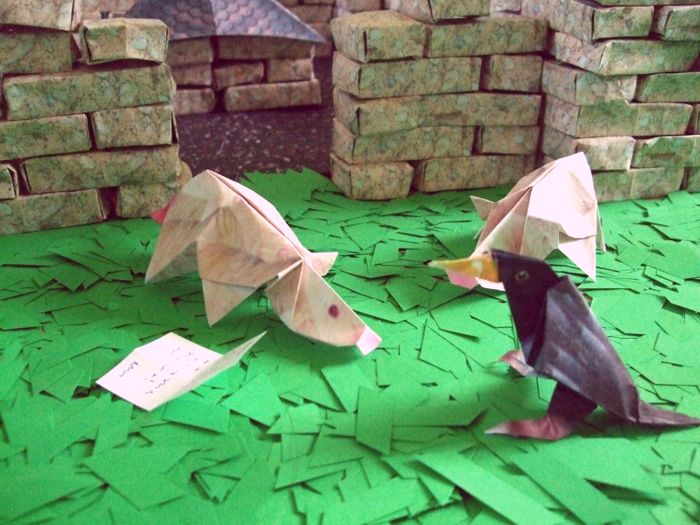 origami animals in front of a castle