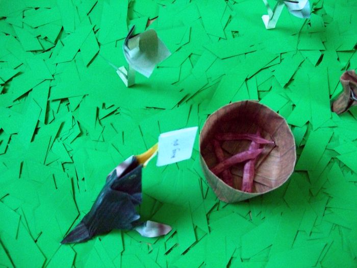 origami worms in a paper bucket