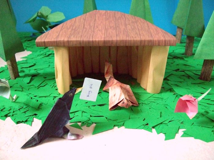 origami squirrel standing in a kirigami house