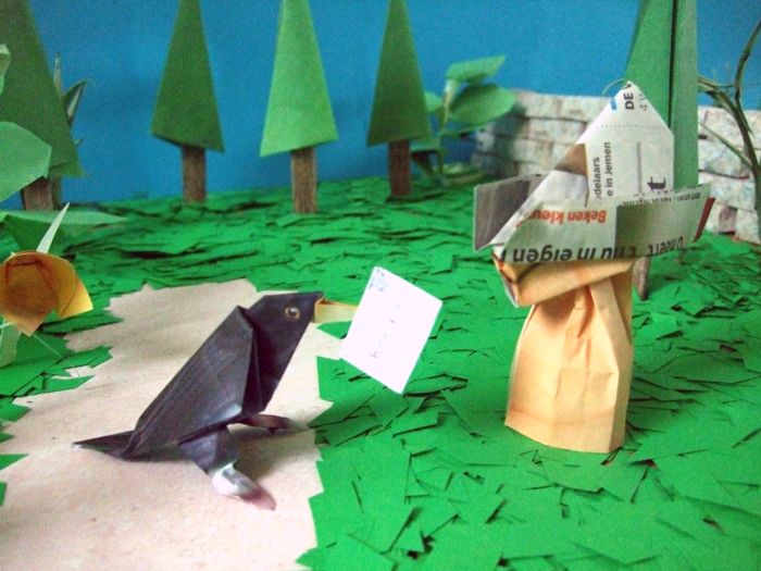 origami bird talking to a person