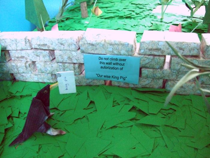 origami bird reading a paper sign