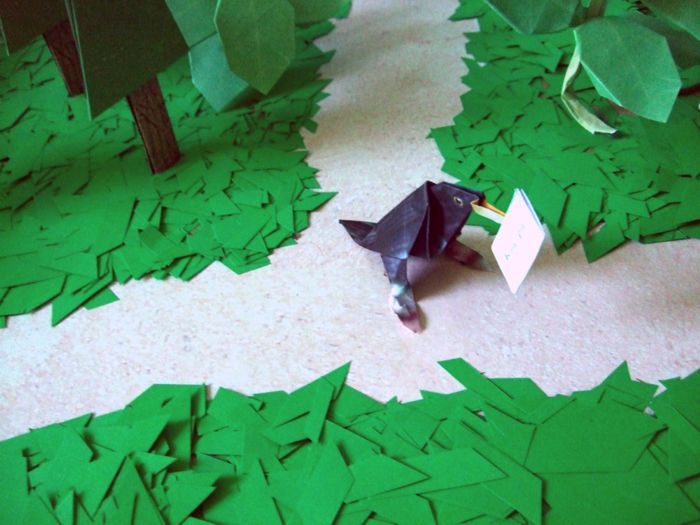 black bird walking about in a paper forest