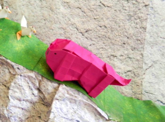 big fat origami pig on a mountain path