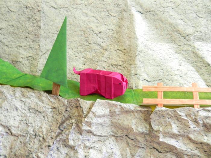 origami piggy on a mountain path