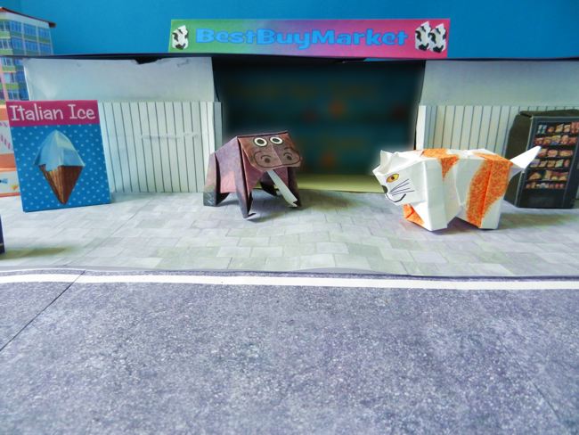 origami cat and hippo in front of a supermarket