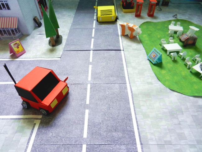 kirigami cars in a papercraft city