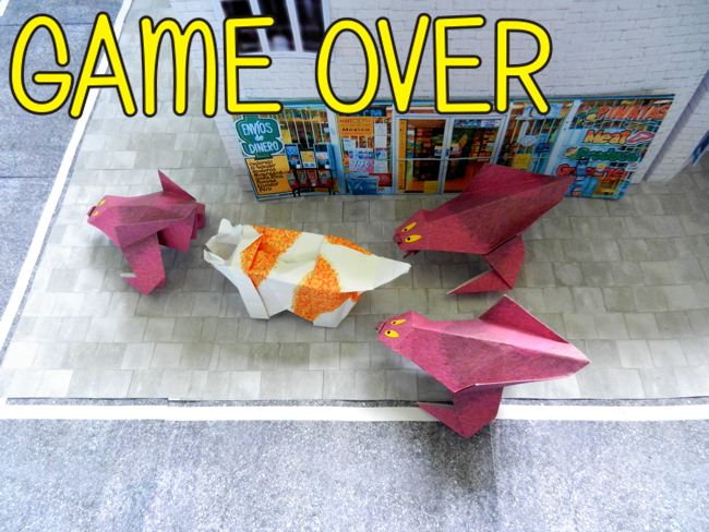 origami monsters holding a cat captive