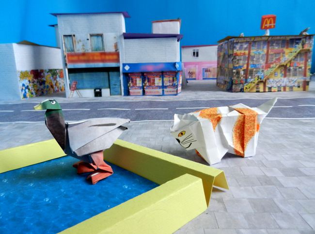 origami duck in a kirigami city