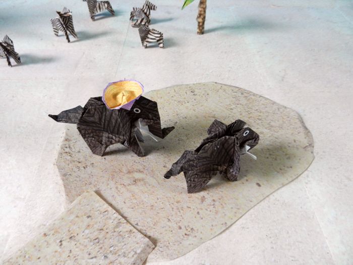 two origami elephants standing on quicksand