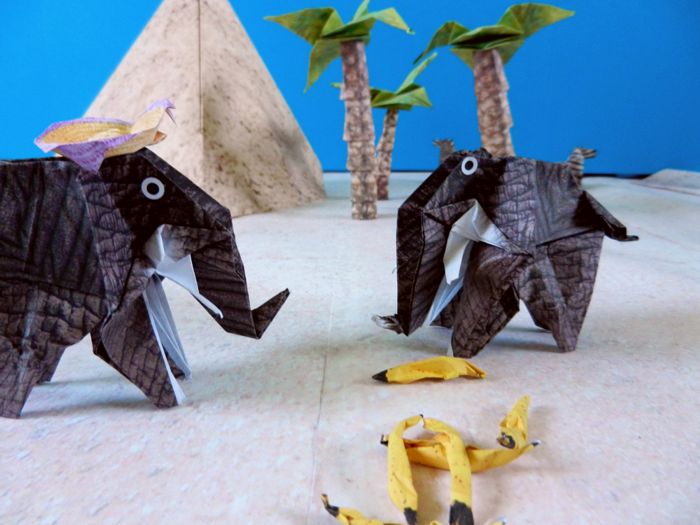 two origami elephants talking about a treasure map