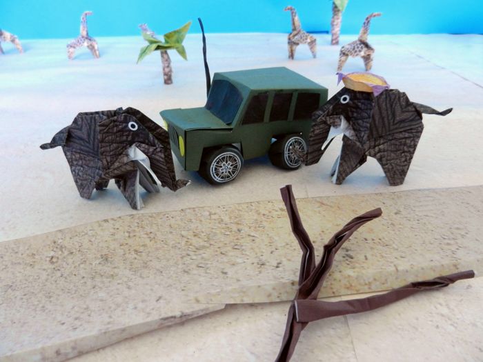 two elephants next to a kirigami jeep