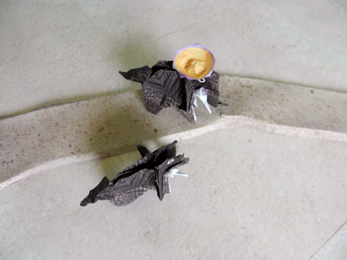 paper elephants walking on a sand path in the desert